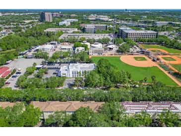 Overhead view of community buildings, a green baseball field, and lush trees at 2329 Shadow View Cir # 2329, Maitland, FL 32751