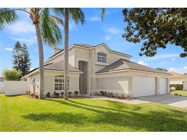 Charming two-story home with a three-car garage, well-manicured lawn, and beautiful landscaping at 239 Longhirst Loop, Ocoee, FL 34761