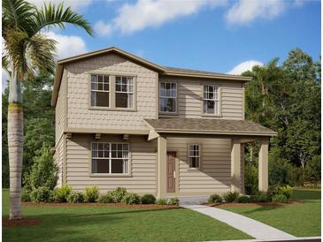 Charming two-story home with covered porch, manicured lawn and tropical landscaping at 2395 Zuni Road, St Cloud, FL 34771