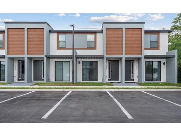 Modern townhomes feature a neutral color palette, sleek lines, and reserved parking at 8802 Positivity Dr, Kissimmee, FL 34747