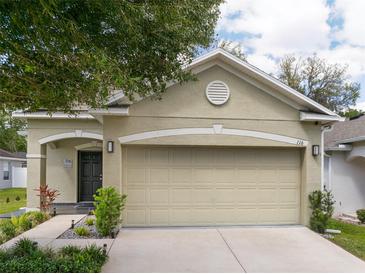 Charming home featuring a two-car garage, manicured landscaping, and classic architectural details at 116 Hurst Ct, Deland, FL 32724