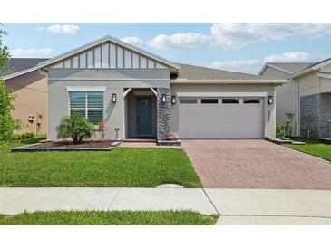 Charming single Gathering home featuring a well-manicured lawn and attached two-car garage at 2905 Tupelo Loop, St Cloud, FL 34772