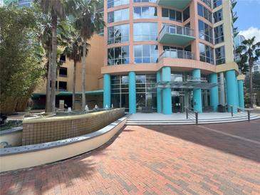 Beautiful condominium building with a water feature and towering palm trees enhancing the curb appeal at 322 E Central Blvd # 908, Orlando, FL 32801