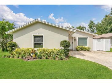 Charming single-story home with manicured lawn and lush landscaping at 5345 Sunrise Blvd, Orlando, FL 32803
