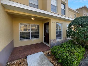 Charming two-story home showcasing a covered front entrance with brick-paved detail and a manicured garden at 5413 River Rock Rd, Lakeland, FL 33809