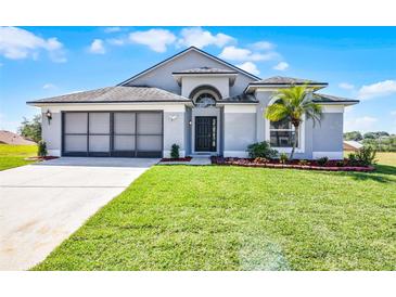 Charming single-story home with well-manicured lawn and a two car garage at 7606 Fordham Creek Ln, Orlando, FL 32818