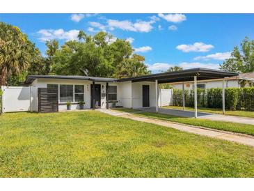 Charming single-story home featuring a well-manicured lawn and convenient carport at 843 W Swoope Ave, Winter Park, FL 32789