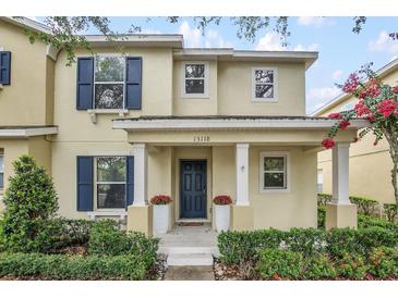 Charming two-story home featuring a welcoming entrance with blue shutters and a well-maintained landscaped yard at 13118 Honey Locust Dr, Orlando, FL 32828