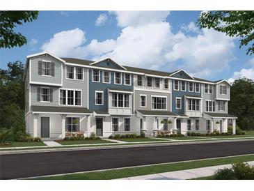 Charming new townhomes featuring various color schemes, covered entryways, and well-manicured front lawns at 2033 Leysmill Aly # 7, Orlando, FL 32803