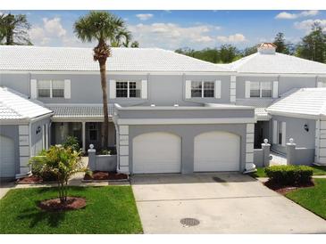 Charming two-story townhome with a well-maintained lawn and a two-car garage at 4917 Walden Cir, Orlando, FL 32811