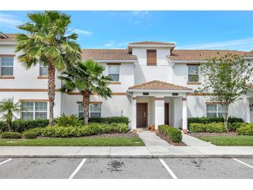 Townhouse exterior featuring well-maintained landscaping and a welcoming entrance at 8969 Stinger Dr, Davenport, FL 33896