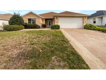 Charming one-story home with manicured lawn and welcoming front entrance, perfect for suburban living at 9665 Se 125Th Ln, Summerfield, FL 34491