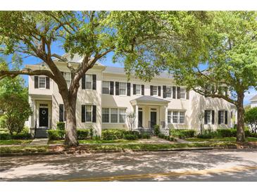 Charming two-story townhome featuring a well-maintained lawn and beautiful mature shade trees at 1068 Lake Baldwin Ln, Orlando, FL 32814