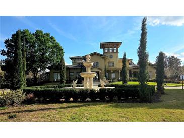 An elegant exterior view featuring a fountain in front of a beautiful two-story building with manicured landscaping at 107 Vista Verdi Cir # 237, Lake Mary, FL 32746