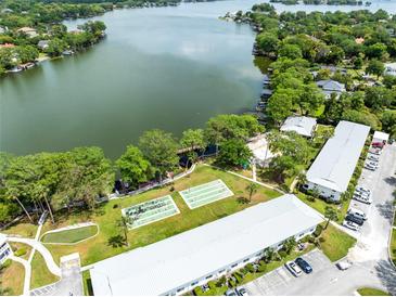 Aerial view of community featuring a lake, lush landscaping, and on-site amenities at 1140 S Orlando Ave # E-1, Maitland, FL 32751