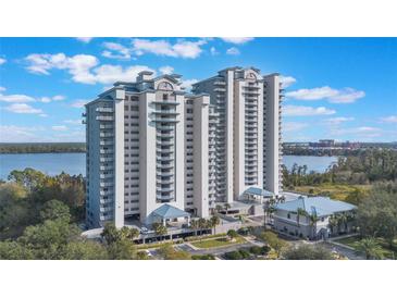 Stunning high-rise condo building with multiple floors and private balconies overlooking the water at 13415 Blue Heron Beach Dr # 208, Orlando, FL 32821
