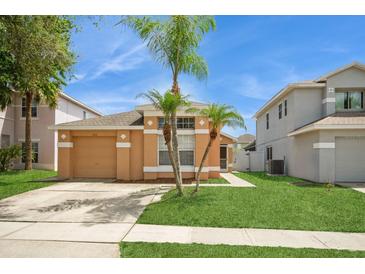 Charming single-story home featuring a well-manicured lawn and a two-car garage at 1413 Timberbend Cir, Orlando, FL 32824