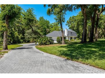 Beautiful home with brick driveway and lush landscaping at 1710 Alvarado Ct, Longwood, FL 32779