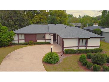 Charming single-story home features a well-manicured lawn and inviting curb appeal at 2100 Shirewood Ct, Winter Park, FL 32792