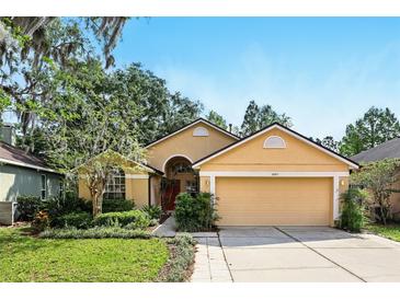 Charming single-story home featuring a well-manicured lawn and a two-car garage at 2987 Sabel Oak Pl, Oviedo, FL 32765