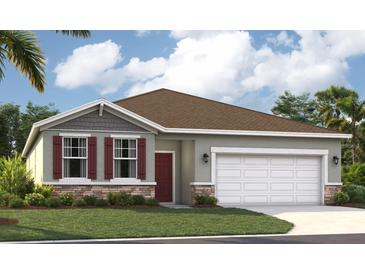 Charming single-Gathering home with a well-manicured lawn, two car garage, and red shutters at 9161 Harris Hawk Dr, Leesburg, FL 34788