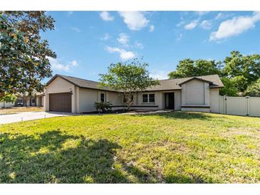 Charming single-story home with well-maintained lawn, mature landscaping, and inviting curb appeal at 9338 Palm Tree Dr, Windermere, FL 34786