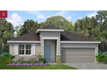 Charming single-story home with a two-car garage, neutral stucco, and an inviting front yard with fresh landscaping at 2030 Firethorn Loop, Haines City, FL 33844