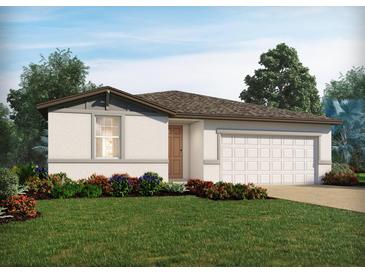 Charming single-story home featuring a well-manicured lawn, flowering bushes, and an attached two-car garage at 2928 Wild Olive Dr, St Cloud, FL 34772