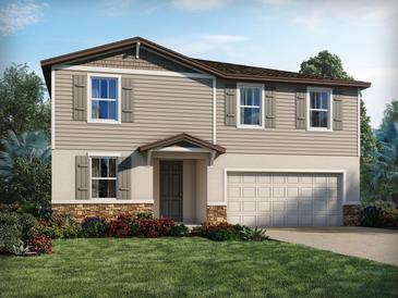 Charming two-story home featuring a two-car garage, stone accents, neutral siding, and a well-manicured lawn at 4705 Jasmine Cir, Leesburg, FL 34748