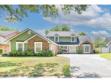 Charming two-story home with a well-manicured lawn and inviting curb appeal at 5330 Keswick Ct, Orlando, FL 32812