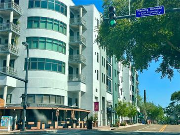 Modern condominium building featuring multiple stories, balconies, and street-level retail space at 10 N Summerlin Ave # 25, Orlando, FL 32801