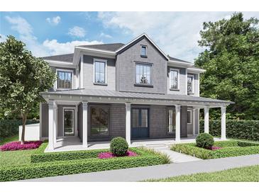 Charming two-story home with a covered porch, manicured landscaping, and gray accents at 1244 Water Maple Dr, Oakland, FL 34787
