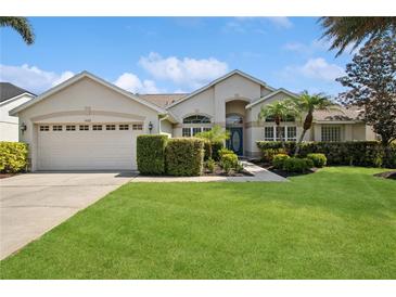 Charming single-story home with a lush green lawn, manicured hedges, and a welcoming front entrance at 14313 Roxshire Dr, Orlando, FL 32837