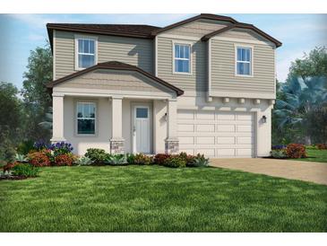 Charming two-story home featuring a manicured lawn and a two-car garage at 2240 Hen Rd, Minneola, FL 34715