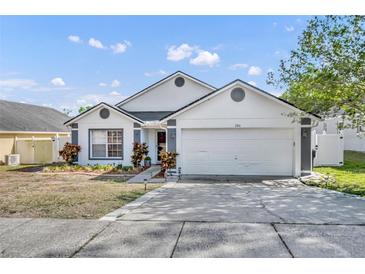 Charming single-story home featuring a two-car garage and well-maintained landscaping at 280 Bay St, Apopka, FL 32712