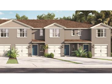 Charming townhome with a two-car garage and lush tropical landscaping at 2903 Canary Ave, Davenport, FL 33837