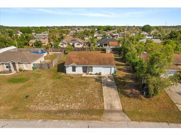 Charming single-story home with a well-maintained lawn and inviting curb appeal in a suburban setting at 3166 Canby Dr, Deltona, FL 32738