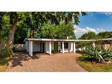 Charming single-story home with a brick driveway and a vibrant green front door at 3425 N Westmoreland Dr, Orlando, FL 32804
