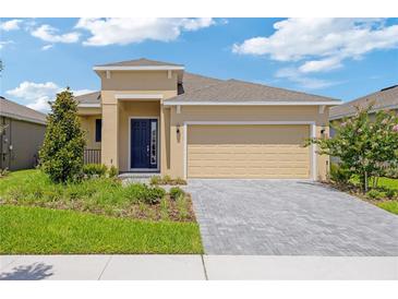 Charming single-story home features a manicured lawn, paver driveway, and inviting front entrance at 503 Silver Palm Dr, Haines City, FL 33844