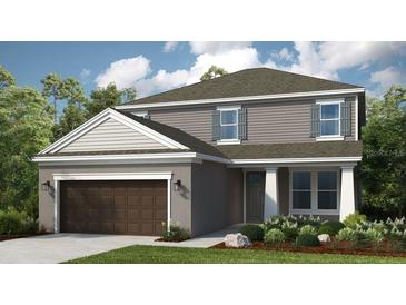 Charming two-story home featuring a two-car garage and classic architectural details at 557 Moon Shell Cir, New Smyrna Beach, FL 32168