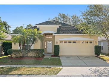 Charming single-story home with well-maintained landscaping and a two-car garage at 9723 Pecky Cypress Way, Orlando, FL 32836