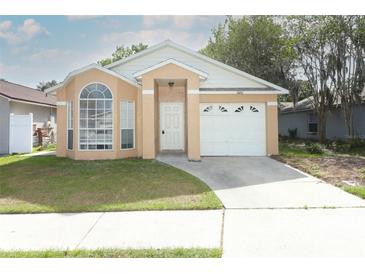 Charming single-story home featuring a well-manicured lawn and an attached garage at 1040 Hamlet Dr, Maitland, FL 32751