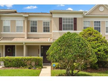 Two-story home with neutral exterior paint, attractive landscaping, and well-maintained lawn at 1530 Tally Cir, Oviedo, FL 32765