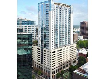 Contemporary high-rise condo building showcasing modern architecture and glass facade at 155 S Court Ave # 1202, Orlando, FL 32801