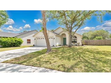 Charming one-story home features a well-maintained lawn, two-car garage and mature shade trees at 2381 Pinebrook Ct, Oviedo, FL 32766