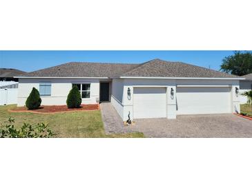 Charming single-story home with a two-car garage and well-maintained landscaping at 332 Blue Lake Cir, Kissimmee, FL 34758