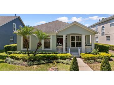Charming single-story home with well-manicured landscaping, complemented by vibrant yellow bushes and youthful palm trees at 336 Sunset Oaks Rd, Winter Garden, FL 34787
