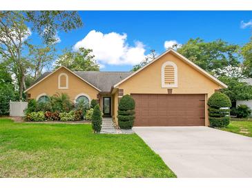 Charming single-Gathering home with a well-maintained lawn, mature trees and appealing curb appeal at 400 Shelby Ct, Apopka, FL 32712