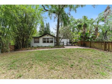 Charming single-story home with lush greenery, landscaping, and a brick walkway leading to the front entrance at 506 S Hyer Ave, Orlando, FL 32801