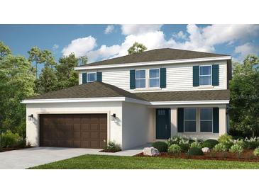 Charming two-story home featuring a well-manicured lawn, attached two-car garage, and lovely blue shutters at 549 Moon Shell Cir, New Smyrna Beach, FL 32168